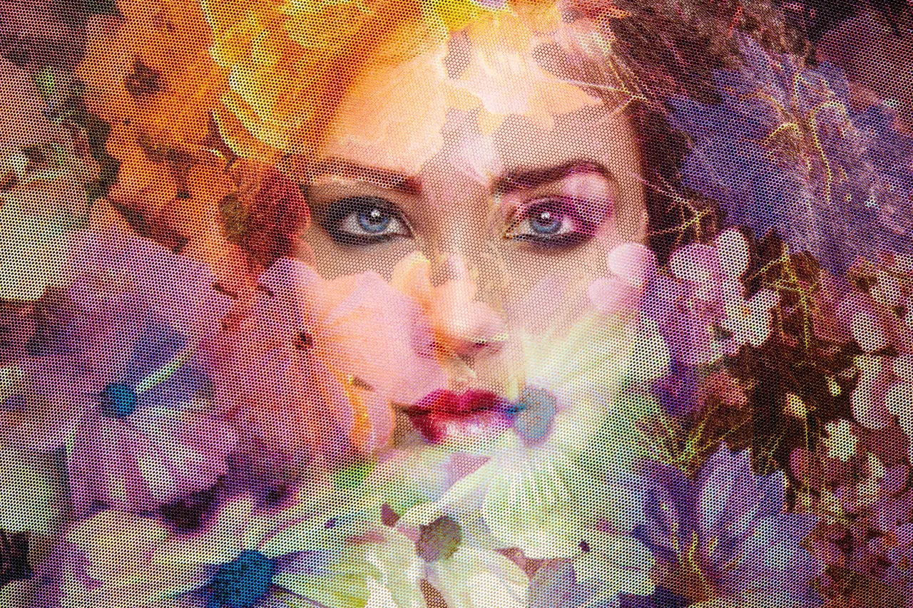 A woman’s face emerging through flowers